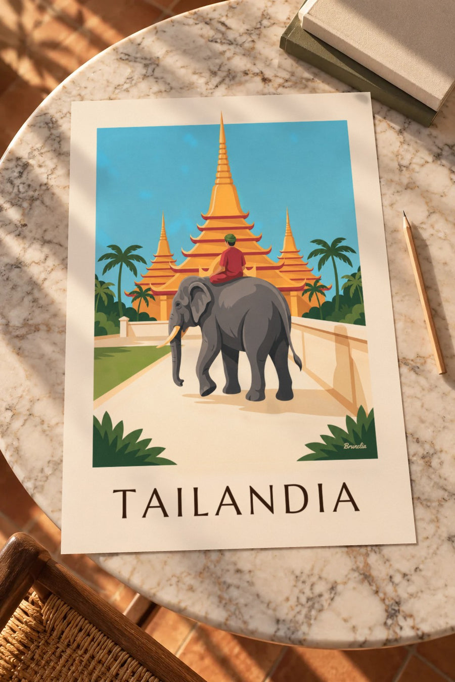 Cartaz de elefante e pagodes douradas na Tailândia: pousado numa mesa