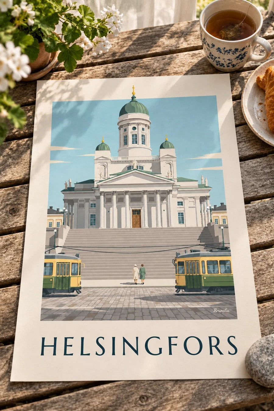 Affisch med spårvagnar och Helsingfors lutherska domkyrka: liggande på ett bord