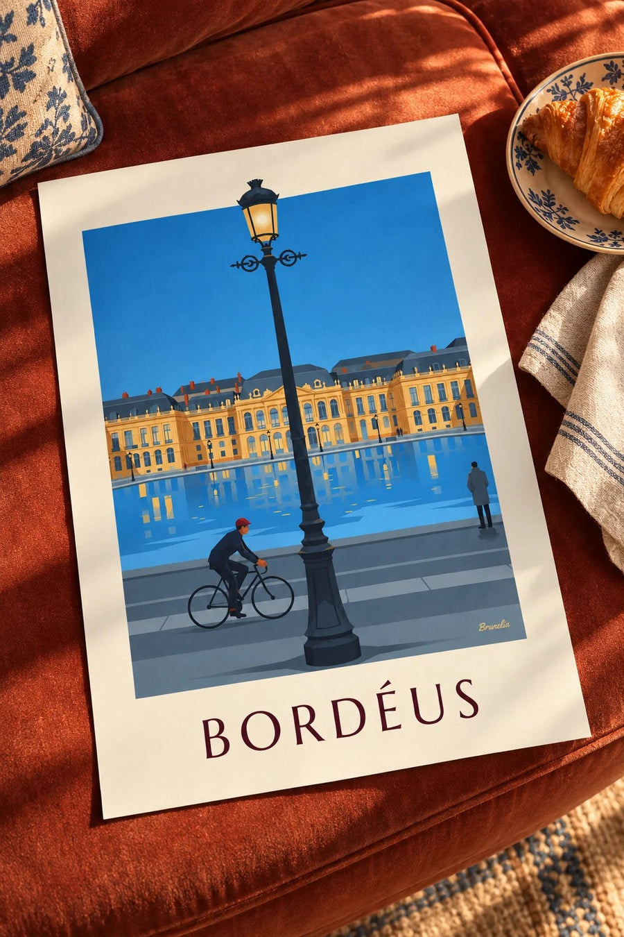 Póster de ciclista diante do espelho de água de Bordéus ao crepúsculo: pousado numa mesa